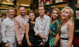 Žinomi žmonės tapo gyvomis gėlėmis puoštų skrybėlaičių parodos „eksponatais“